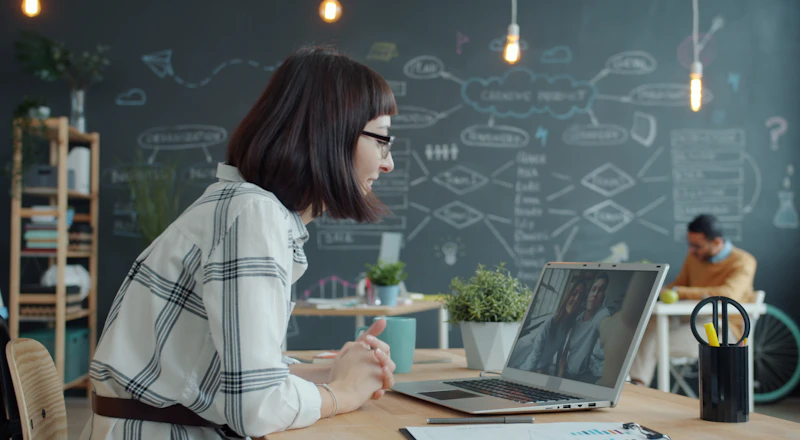 A woman on an international video call in an office